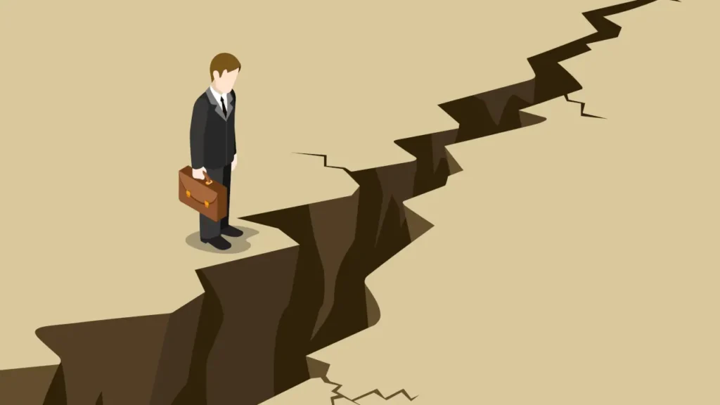 Desenho de um homem em frente a uma rachadura enorme no chão, impedindo ele passar par ao outro lado